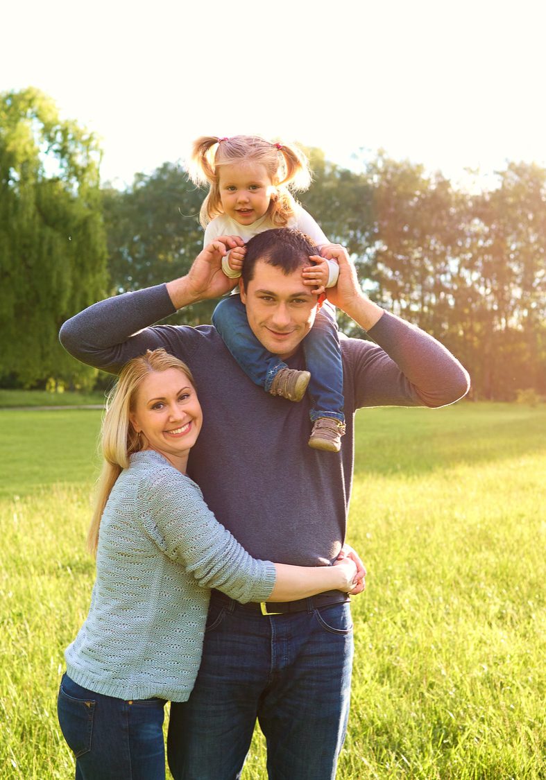 Happy family having fun outdoors and smiling. Mom,dad and daughter